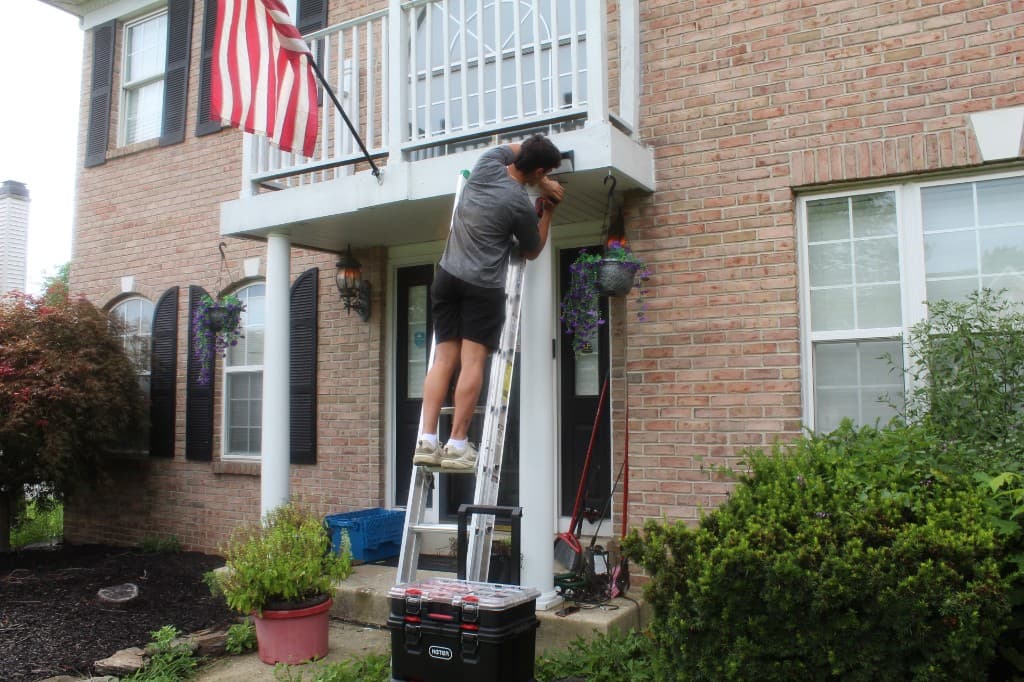 Outdoor smart home installation from a ladder